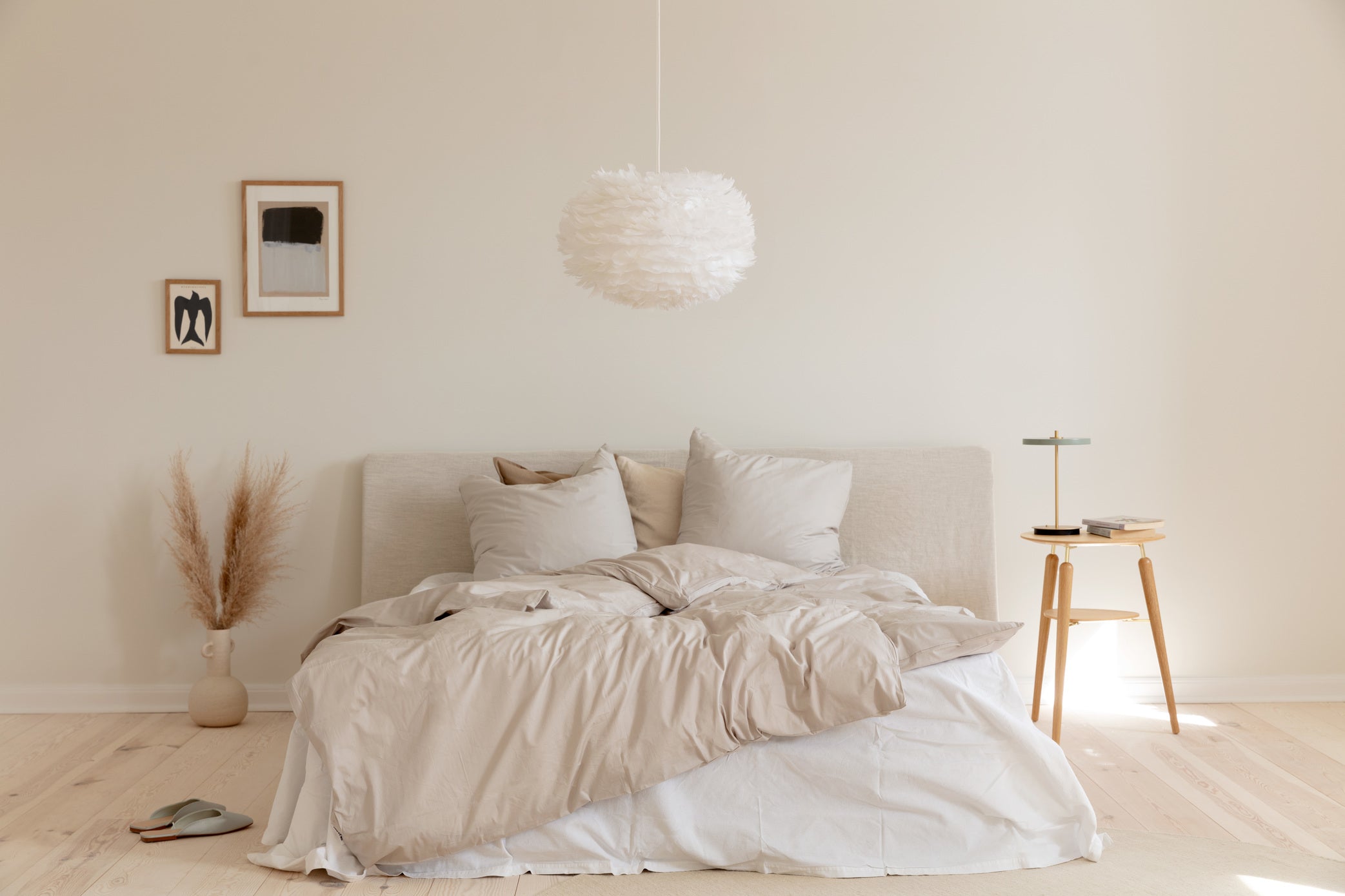 Bedroom in soft daylight with sofa and table lamp