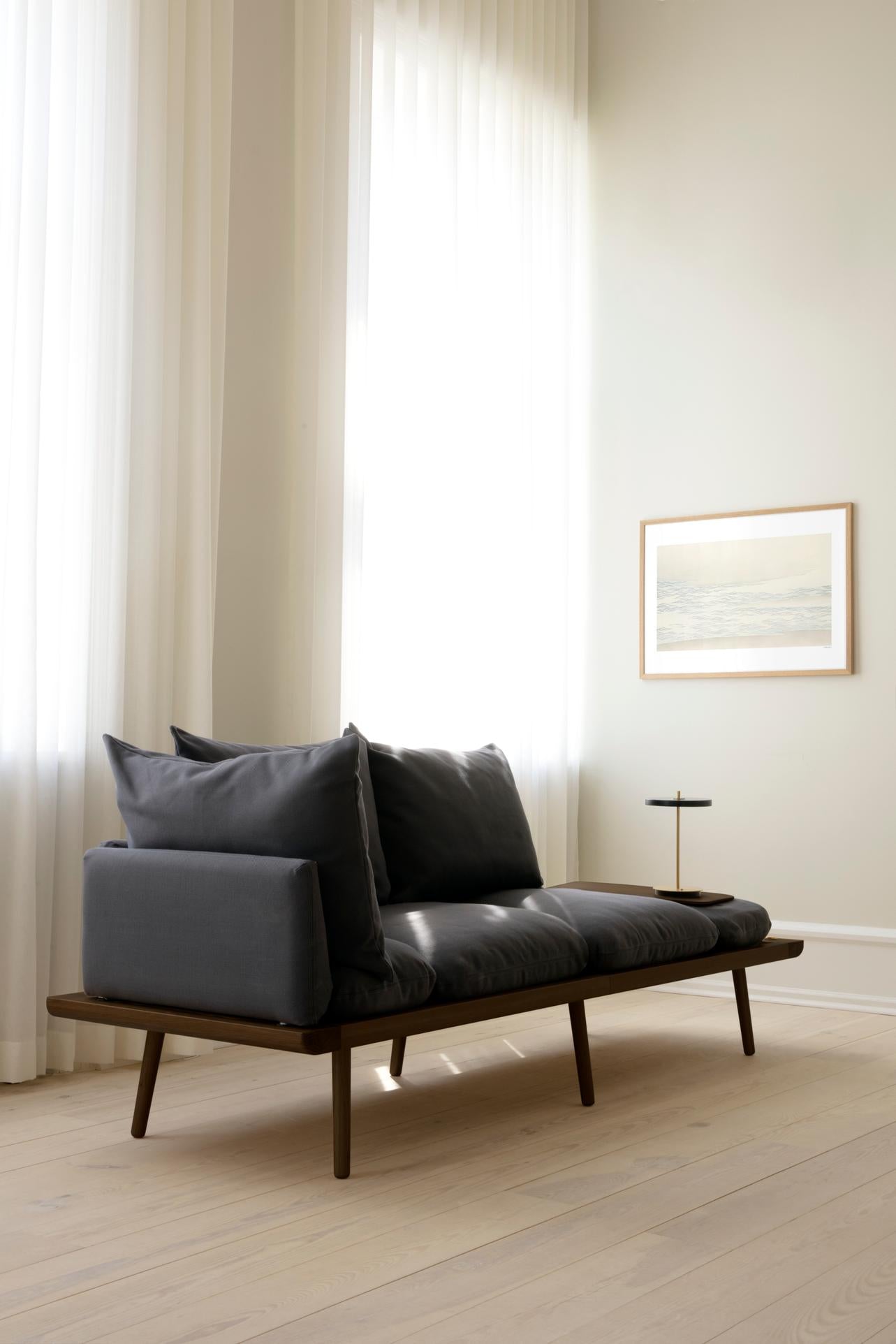 Living room in soft daylight with sofa and table lamp